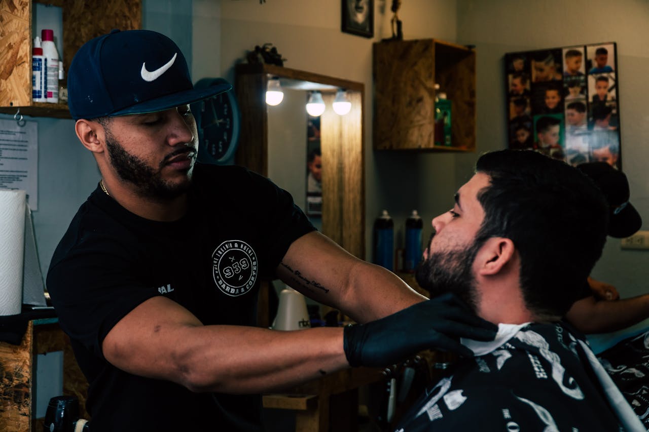 Barber skillfully trims a mans hair in a modern barbershop setting.